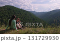 Mother and son enjoying scenic mountain vista 131729930
