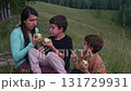 Family enjoying green apples in nature 131729931
