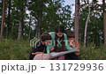 Family reading map in forest 131729936