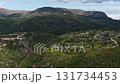 Aerial view of a mountain village nestled in a lush green valley in norway 131734453