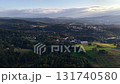 A breathtaking aerial view showcases tranquil hills and lush greenery set in a stunningly picturesque landscape 131740580