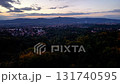 A captivating urban scenery that beautifully showcases a lush valley and city skyline during a gorgeous sunset 131740595