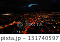 A breathtaking night city view presents an array of brightly lit streets paired with moody, drifting clouds 131740597