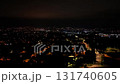 Enjoy a mesmerizing nighttime view of urban lights and shadows from above, offering a stunning perspective 131740605
