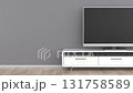 Flat screen TV on white cabinet with soundbar and subwoofer in room 131758589
