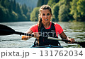 Strong athletic woman paddling a kayak with intensity and power during a water sport activity 131762034