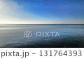 Aerial view of gliding over emerald green waters towards the horizon under blue skies Aerial view of gliding over emerald green waters towards the horizon under blue skies 131764393