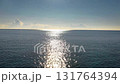Drone footage of a flight towards the sun over the sea shining in the morning sun Drone footage of a flight towards the sun over the sea shining in the morning sun 131764394