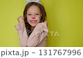 A charismatic comical girl with makeup in the guise of a rabbit with white ears is having fun and laughing, rejoicing at the approach of the Easter Holiday. 131767996