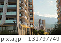 Modern residential complex surrounded by palm trees, showcasing contemporary urban design. 131797749