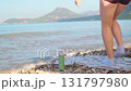 Relaxation and harmony woman doing yoga on sand with sea and sun in the background peaceful outdoor scene 131797980
