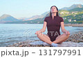 Meditation practice on beach for inner balance mental health outdoor coastal wellness and relaxation 131797991