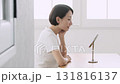 A Japanese woman in her 40s checking her skin condition in front of the mirror 131816137