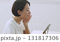 A Japanese woman in her 40s checking her skin condition in front of the mirror 131817306