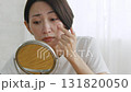 Middle-aged woman checking her skin condition in the mirror 131820050