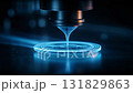 Close-up of precision manufacturing equipment working with blue light effect 131829863