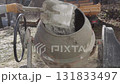 worker shovels concrete mixer 131833497