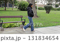Teenager Sitting on Park Bench Then Walking Away 131834654