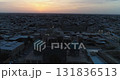 A drone flies over the architectural complex Poi-Kalon among old houses in Bukhara, Uzbekistan. Early cloudy morning 131836513