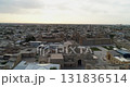 A drone flies over the architectural complex Poi-Kalon among old houses in Bukhara, Uzbekistan. Early cloudy morning 131836514