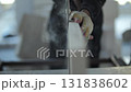 Construction worker cutting aerated concrete block with electric saw 131838602