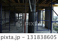 Scaffolding and supports inside unfinished high-rise concrete building 131838605