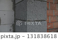 Corner of unfinished wall made of concrete and brick blocks at construction site 131838618