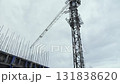 Tower crane at construction site of high-rise concrete building structure 131838620