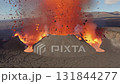 View of the volcano eruption and shooting out od hot magma and rock fragments to the air. 131844277
