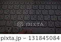 The fingers move on the computer keyboard, which is lit up in the darkness. 131845084