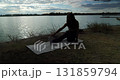 Participating in a Yoga Practice near the Water at Sunset, Cultivating Inner Peace and Calmness 131859794