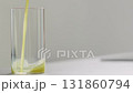 Slow motion pour celery juice in glass on concrete countertop with copy space 131860794