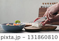 Man cutting feta cheese on olive wood board for greek salad 131860810