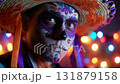 Man dressed for Dia de Muertos celebration in Mexico during sunset with elaborate calavera makeup 131879158