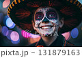Man dressed for Dia de Muertos celebration in Mexico during sunset with elaborate calavera makeup 131879163