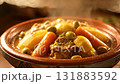 Steaming authentic Moroccan chicken or lamb tagine being prepared and served 131883592