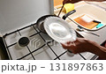 A woman is preparing a meat dish at home in the kitchen.Concept for cooking and food preparation. 131897863