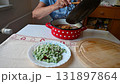 A woman is preparing a meat dish at home in the kitchen.Concept for cooking and food preparation. 131897864