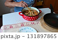 A woman is preparing a meat dish at home in the kitchen.Concept for cooking and food preparation. 131897865