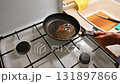 A woman is preparing a meat dish at home in the kitchen.Concept for cooking and food preparation. 131897866