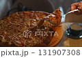 Sharing a delicious pizza in a cozy restaurant setting 131907308