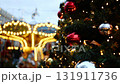 Decorated Christmas Tree Against Lighting Carousel, Merry Go Round On Christmas Market 131911736