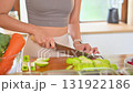 Young woman in activewear organizing nutritious food portions for the week 131922186