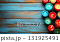 Colorful burning candles with dancing flame on rustic blue wooden background with empty space 131925491