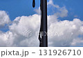 A clear view of industrial machinery against a blue sky with fluffy clouds, showcasing modern engineering. 131926710