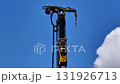 A detailed view of a crane arm meticulously showcasing its structural design against a vibrant blue sky backdrop 131926713