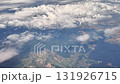This aerial view showcases lush landscapes and captivating cloud formations seen from high above the earth 131926715