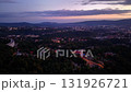 Stunning aerial view of a vast cityscape at sunset, showcasing the remarkable beauty of urban life alongside nature 131926721