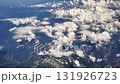 Stunning aerial footage beautifully showcases fluffy clouds drifting gracefully above vibrant green landscapes 131926723