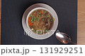 Eating hot meat soup with vegetables 131929251